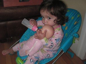 Sophie feeding her baby a bottle