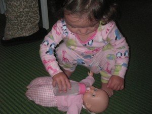 Sophie feeding her baby a bottle  - not the way here Daddies taught her.
