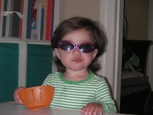 Sophie with her sunglasses eating a snack