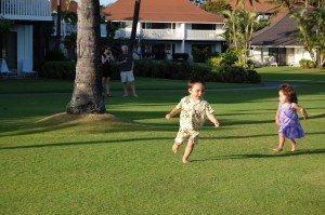 Evan playing on the grass near the beach just before sunset.