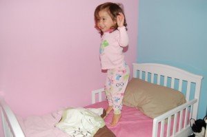 Sophie jumping on her new bed- a whole lot better than a mattress on the floor!