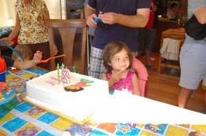 Sophie gets ready to blow out the candles on her cake on her Saturday birthday party