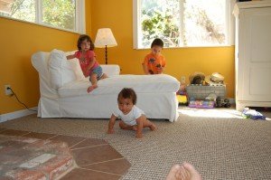 Evan and Sophie watch as Max takes some of his first crawls.